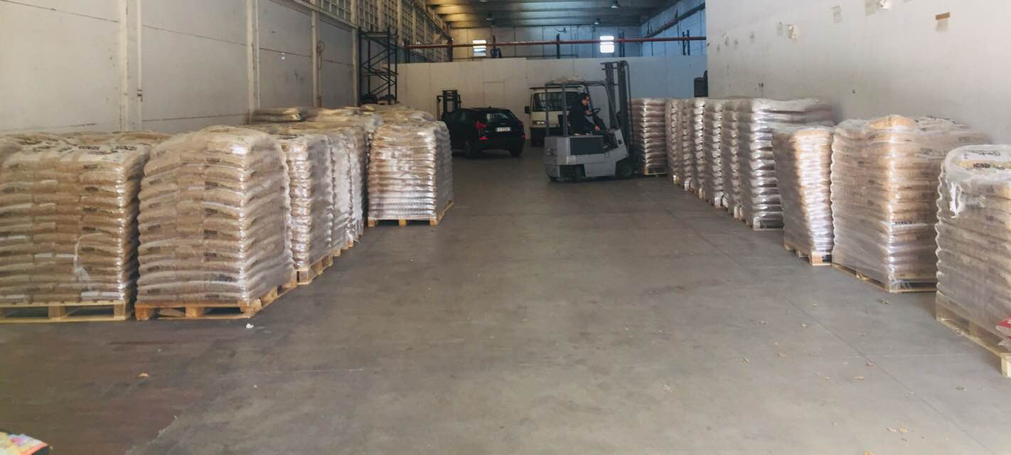 Palletised wood pellet bags arranged along a warehouse aisle Palletised wood pellet bags arranged along a warehouse aisle